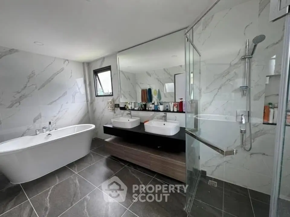 Luxurious modern bathroom with marble walls and dual sinks