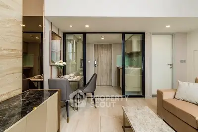 Modern living room with open kitchen and elegant dining area in a stylish apartment.