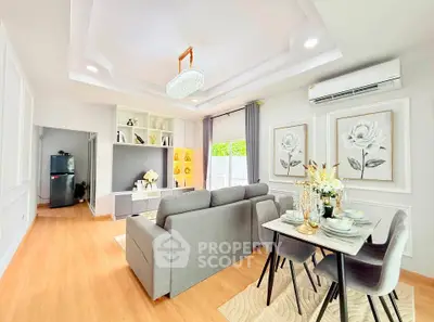 Elegant living room with modern decor, featuring a cozy dining area and stylish lighting, perfect for entertaining.