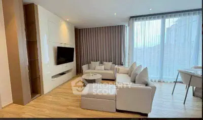 Spacious modern living room with large windows and elegant furniture
