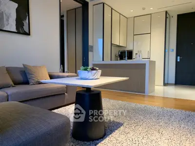 Modern open-plan living room and kitchen with stylish decor and neutral tones.