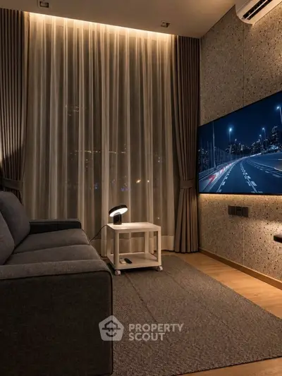 Modern living room with sleek design, featuring a large TV, cozy sofa, and ambient lighting.