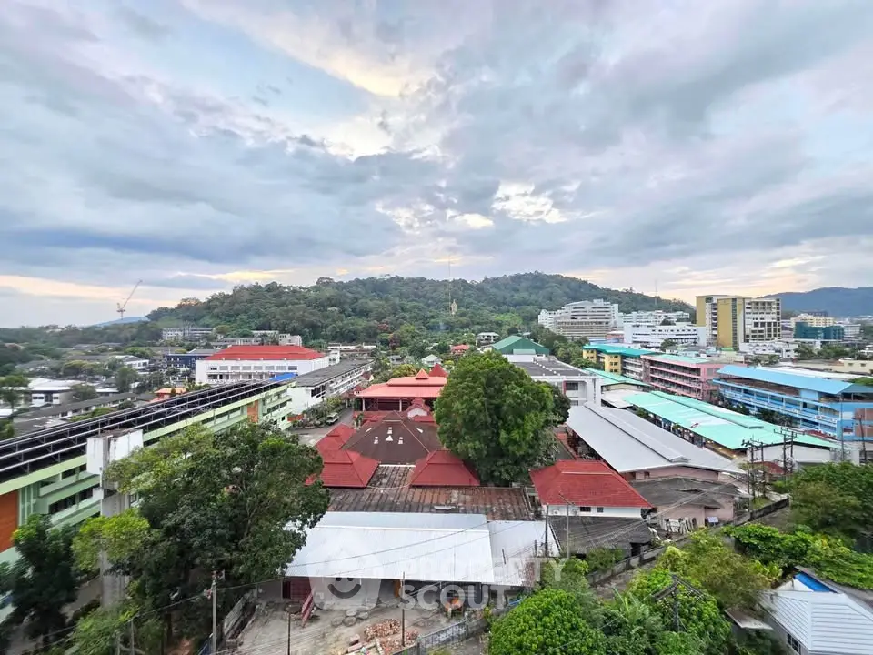 Stunning panoramic view of urban landscape with lush greenery and vibrant rooftops, perfect for city living.