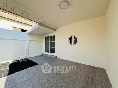 Spacious covered patio with modern design and tiled flooring