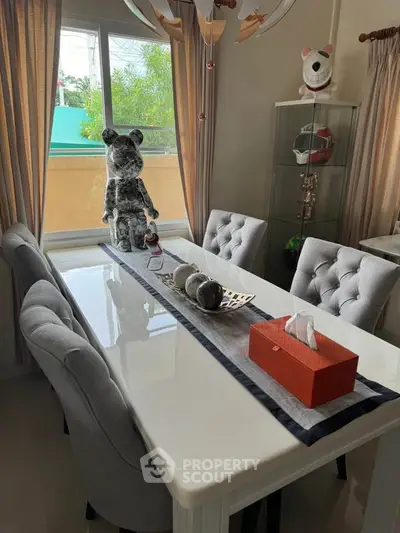 Elegant dining room with plush chairs and decorative centerpiece, perfect for stylish gatherings.