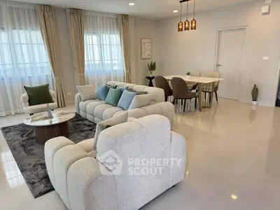 Spacious modern living room with elegant dining area and plush seating