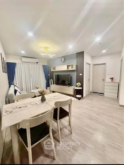 Modern living room with stylish decor and dining area in open layout apartment.