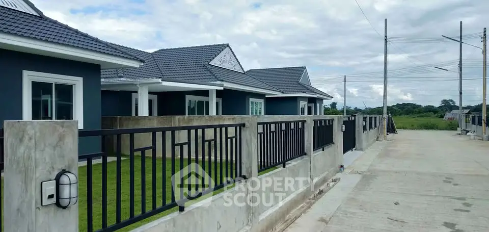 Modern suburban homes with sleek design and spacious front yards in a peaceful neighborhood.