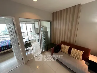 Modern apartment interior with living room, kitchen, and balcony view.