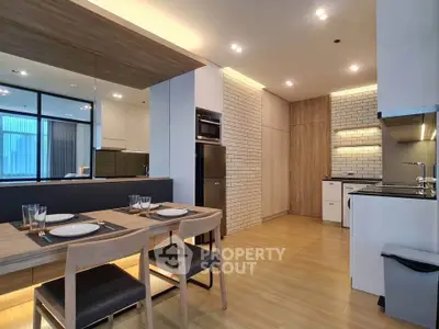 Modern kitchen with open layout and stylish dining area in contemporary apartment.