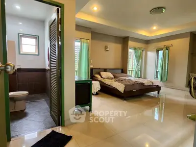 Spacious bedroom with ensuite bathroom and large windows for natural light.