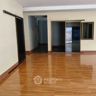 Spacious interior with glossy wooden flooring and sliding glass doors