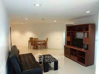 Spacious living room with modern furniture and dining area in open layout.