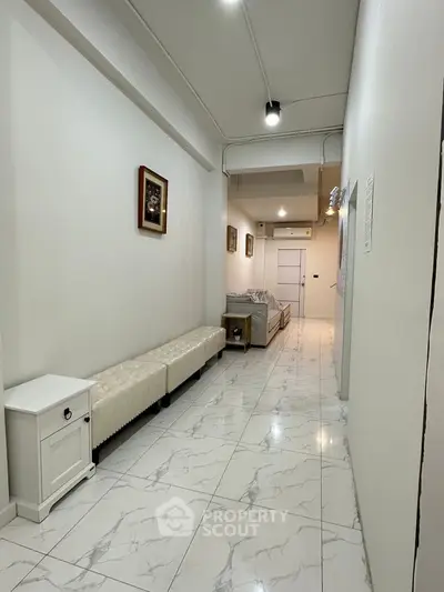 Spacious hallway with elegant marble flooring and stylish decor