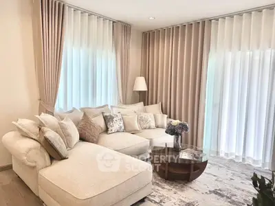 Elegant living room with plush sofa, stylish curtains, and chic decor in a modern home.