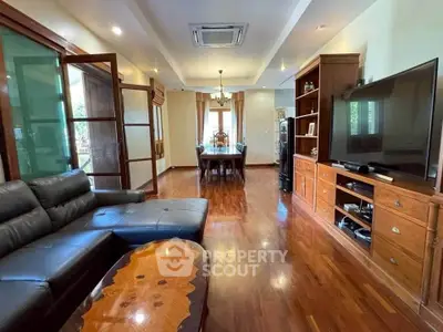Spacious living room with elegant wooden flooring and modern furniture