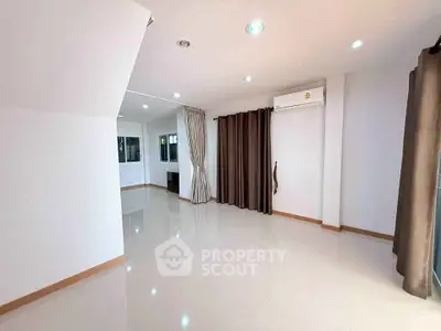 Spacious unfurnished living room with air conditioning and large windows