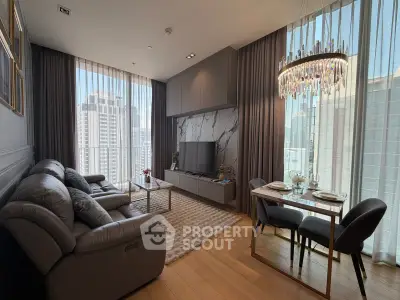 Luxurious modern living room with city view, elegant chandelier, and cozy seating area.