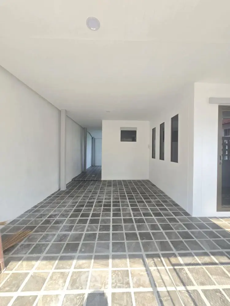 Spacious modern parking area with tiled flooring in contemporary building