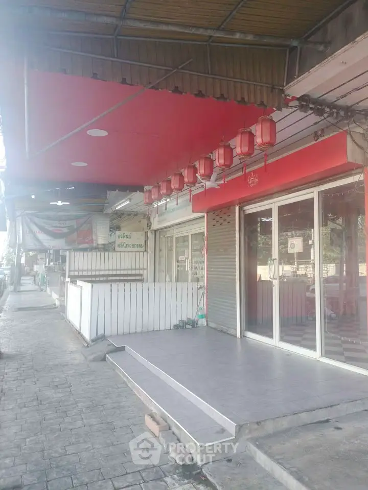 Charming commercial property with red lanterns and modern glass facade, ideal for business opportunities.
