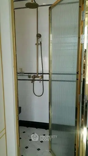 Elegant bathroom with gold accents and modern shower design