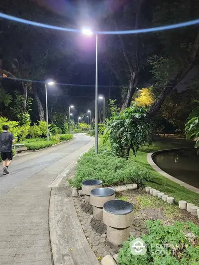 Charming night garden path with lush greenery and modern lighting, perfect for serene evening strolls.