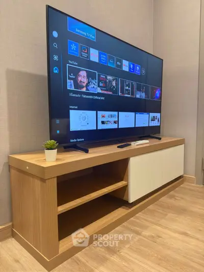 Modern living room with sleek TV setup and stylish wooden console