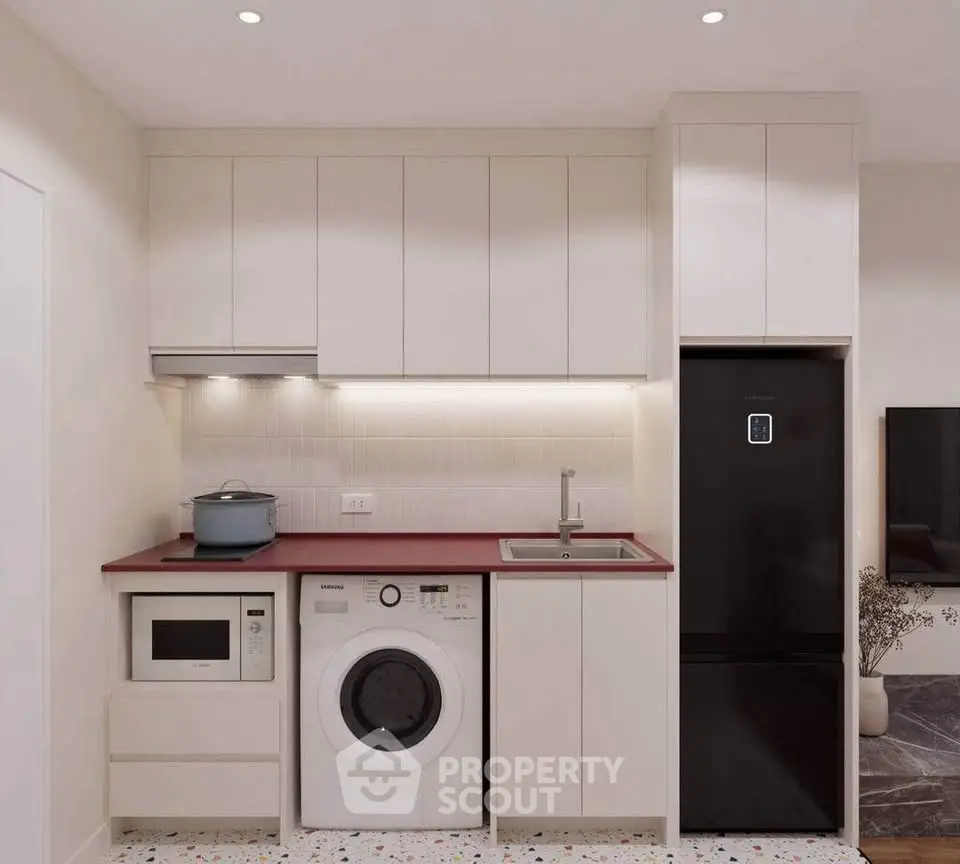 Modern compact kitchen with integrated appliances and sleek cabinetry