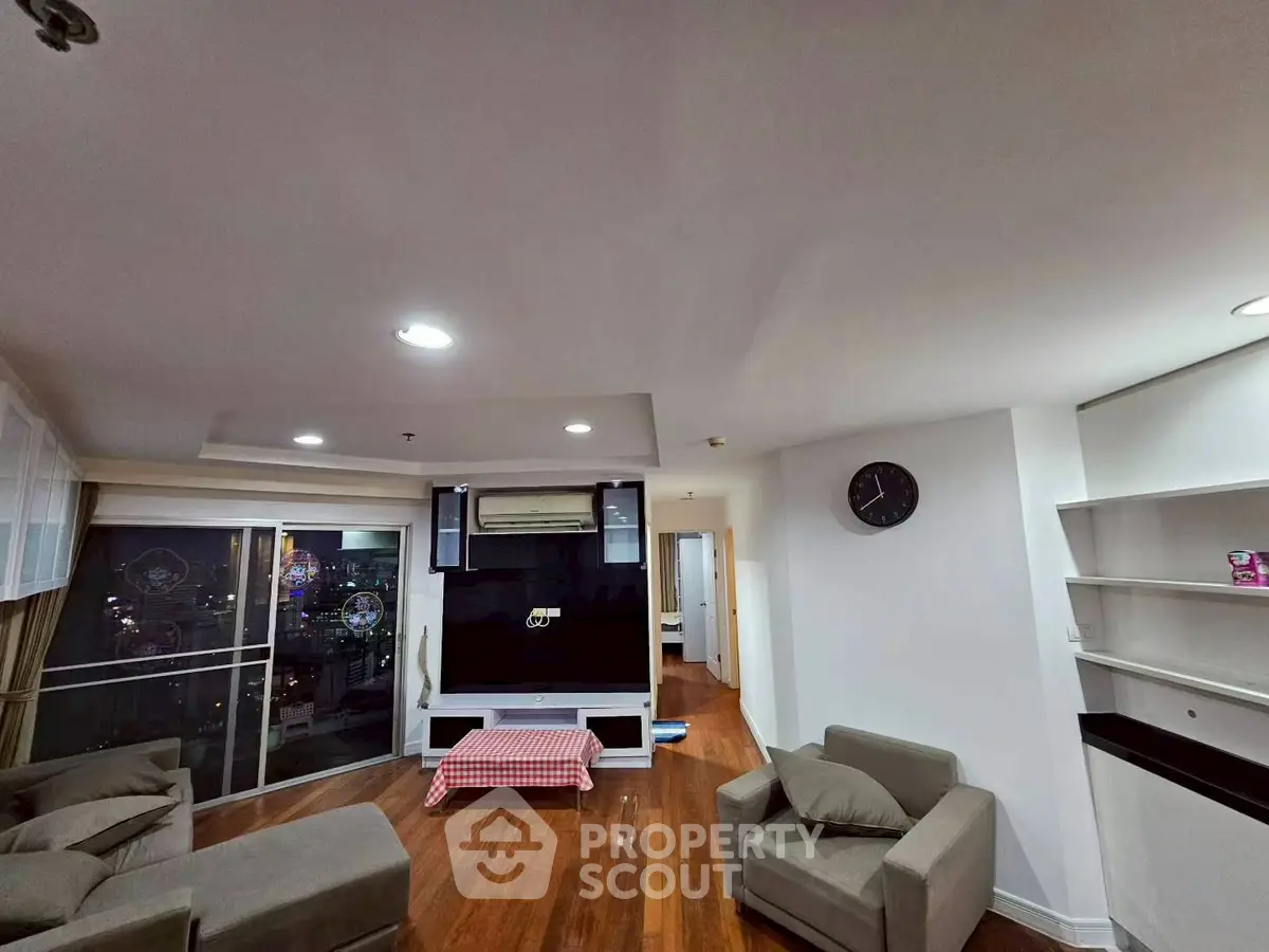 Spacious living room with modern decor and city view balcony