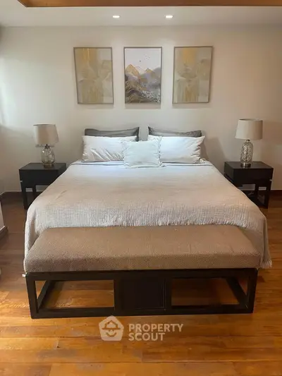 Luxurious bedroom with elegant decor and cozy ambiance, featuring a king-sized bed and stylish lighting.