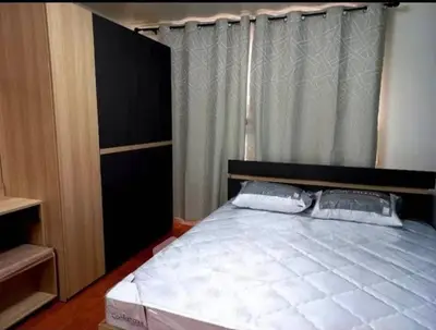 Cozy bedroom with modern wardrobe and stylish curtains, perfect for a restful retreat.