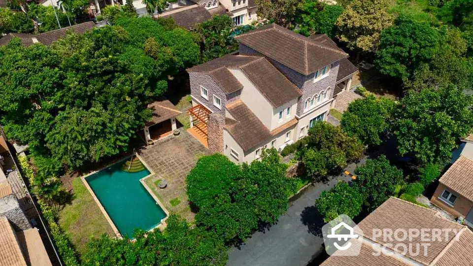 Stunning aerial view of luxurious villa with private pool and lush greenery