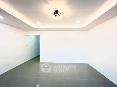 Spacious modern living room with elegant lighting and tiled flooring