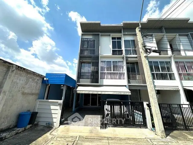 Modern three-story townhouse with sleek design and spacious layout in a vibrant neighborhood.