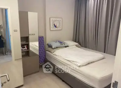 Cozy bedroom with modern decor and ample natural light, perfect for relaxation.