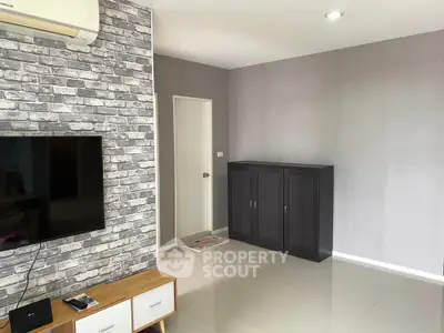 Modern living room with brick accent wall and sleek furniture