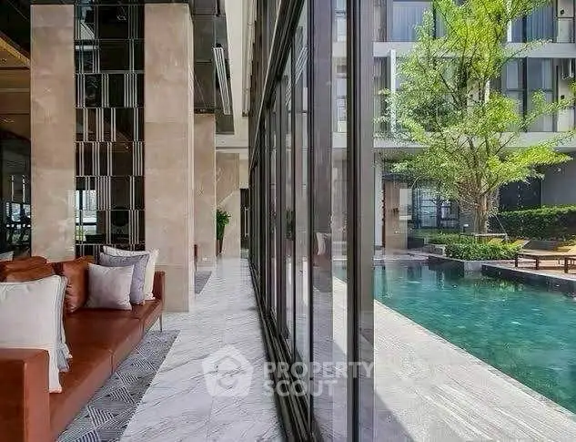 Luxurious poolside view with modern architecture and elegant interiors.