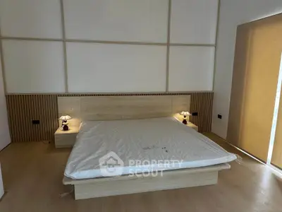 Modern minimalist bedroom with stylish wooden accents and ambient lighting