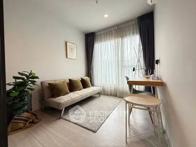 Modern living room with cozy sofa, stylish decor, and natural light through large windows.