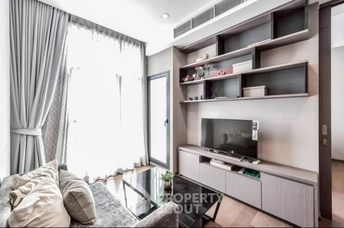 Modern living room with stylish shelving and large window, perfect for relaxation and entertainment.