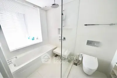 Modern bathroom with sleek white fixtures and a spacious bathtub