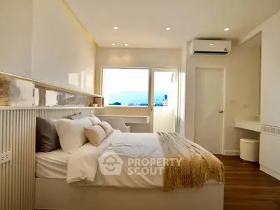 Luxurious bedroom with modern decor and stunning view, featuring cozy bedding and elegant lighting.
