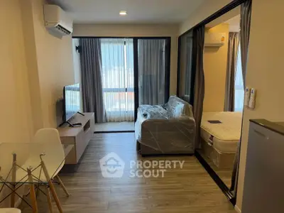 Modern living room with air conditioning and large windows in a stylish apartment.
