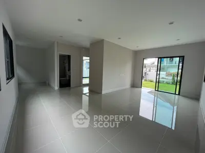 Spacious modern living room with glossy tile flooring and large windows