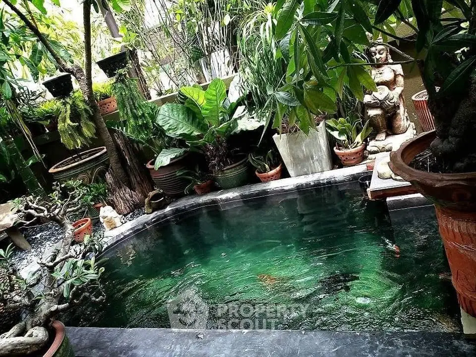 Serene garden with lush greenery and tranquil pond, perfect for relaxation and nature lovers.