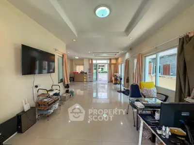 Spacious living room with modern decor and large windows for natural light