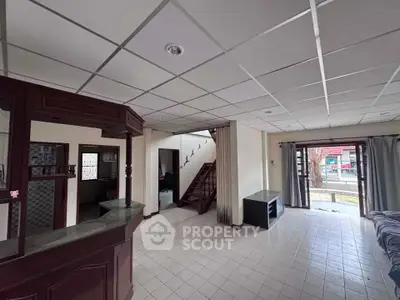 Spacious living room with open layout and staircase, ideal for modern living.