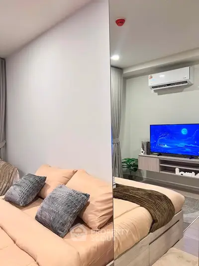 Modern bedroom with cozy bedding and wall-mounted TV, featuring sleek air conditioning unit and stylish decor.