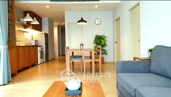 Spacious living room with modern decor and open kitchen layout
