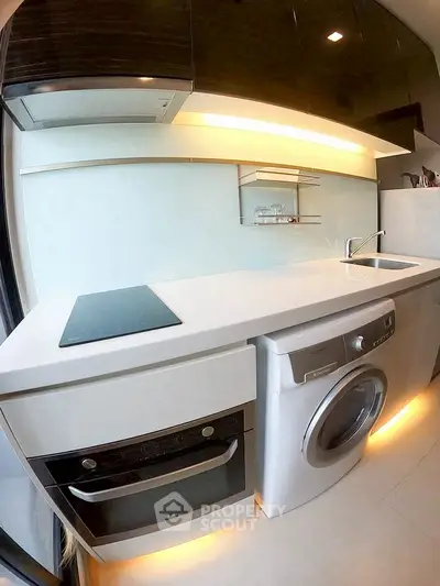 Modern kitchen with sleek appliances and under-cabinet lighting